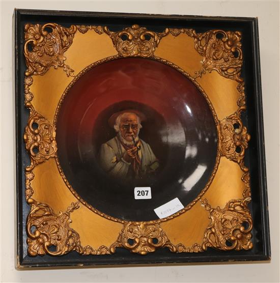 A German porcelain dish in a gilt and ebonised frame height overall 45cm